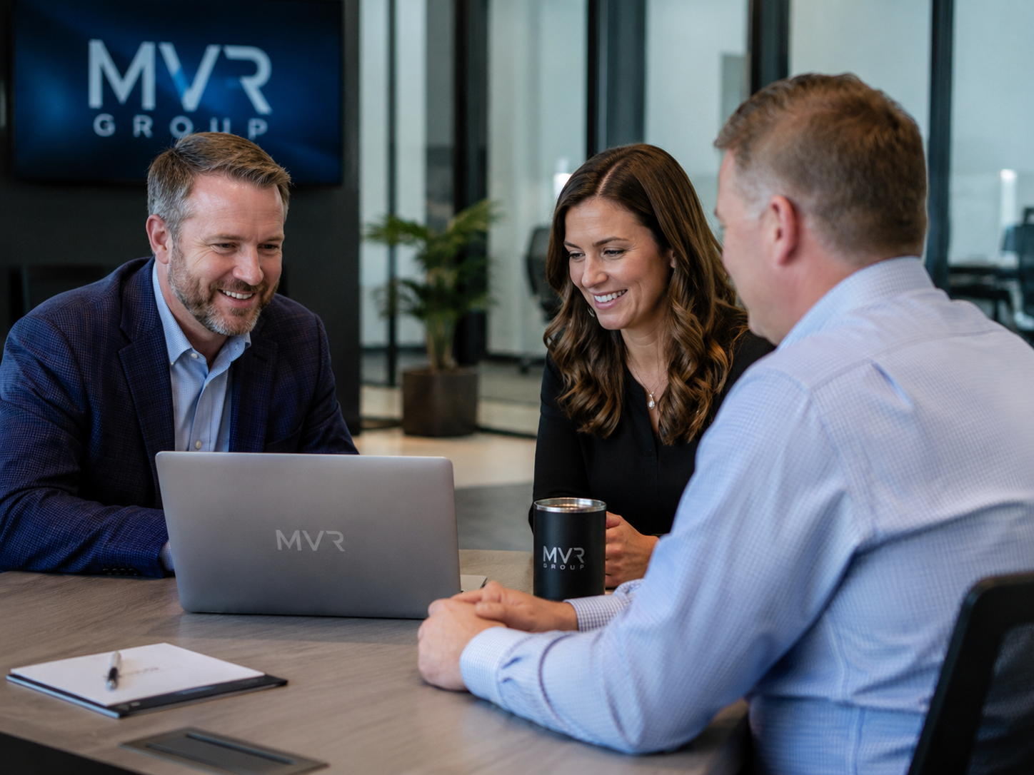 MVR Group team collaborating with clients in a modern office